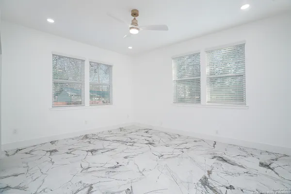 a view of a bedroom with a bed and a window