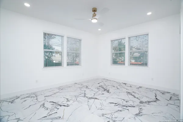 a view of a bedroom with wooden floor and a window