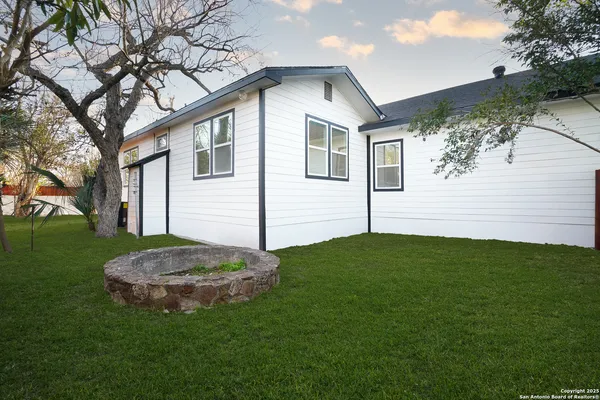 a view of a house with a backyard