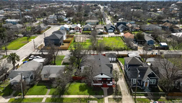 an aerial view of residential houses with outdoor space