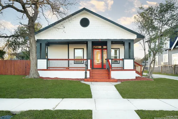 a front view of a house with a yard and porch