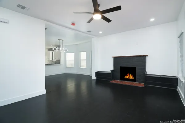 a living room with hard wood floor and a fireplace