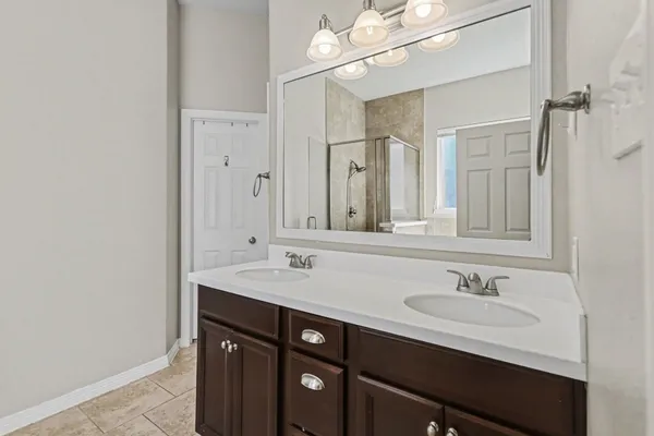 a bathroom with a sink a light fixture and a mirror