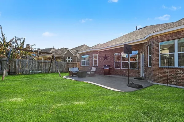 a view of a house with backyard porch and sitting area