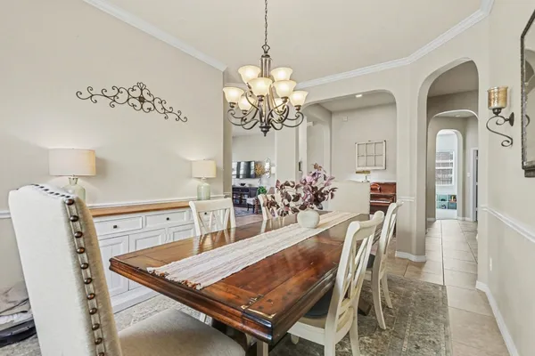 a view of a dining room with furniture and a chandelier