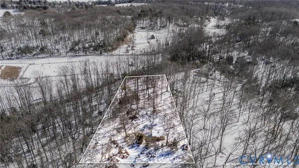 a view of a yard with wooden fence