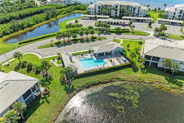 a view of a lake with a house swimming pool and outdoor seating