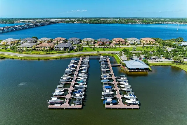an aerial view of ocean and residential houses with outdoor space