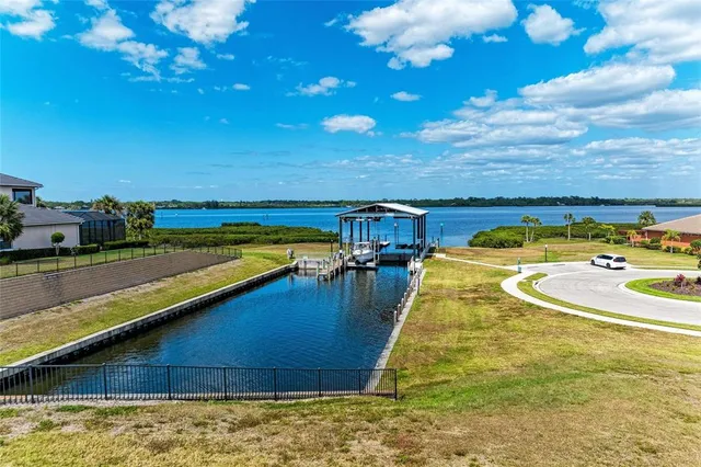 a view of a patio with table and chairs with wooden floor and fence
