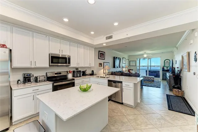 a kitchen with stainless steel appliances granite countertop a refrigerator sink and stove