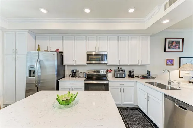 a kitchen with a sink a stove and chairs