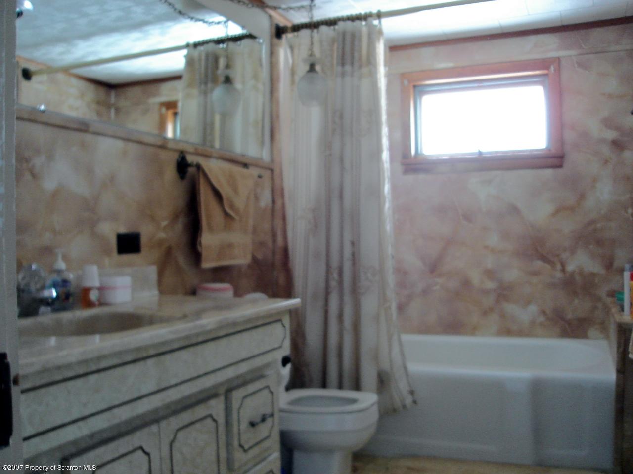 244 Sheldon Hill Road Springville, PA 18844 - Photo 6 of 7 a bathroom with a granite countertop sink toilet and shower