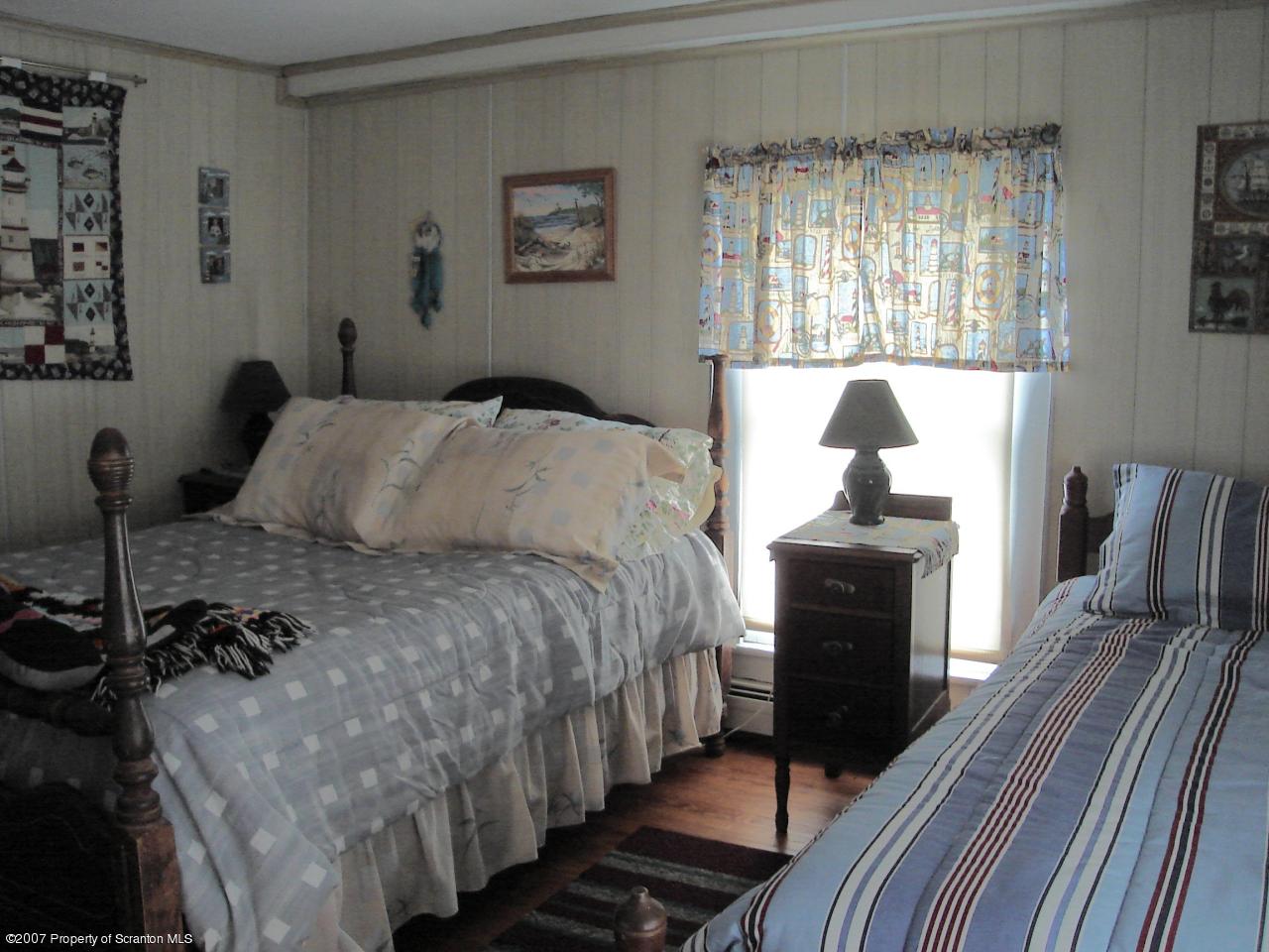 244 Sheldon Hill Road Springville, PA 18844 - Photo 7 of 7 a bedroom with a bed and wooden floor