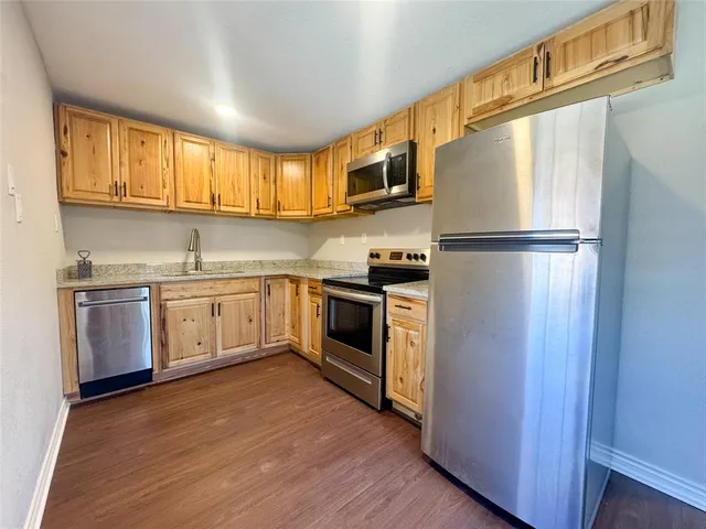 a kitchen with stainless steel appliances a refrigerator sink and cabinets
