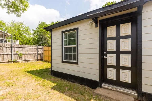 a view of a house with a swimming pool and sitting area