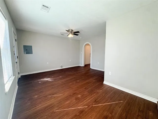 an empty room with wooden floor