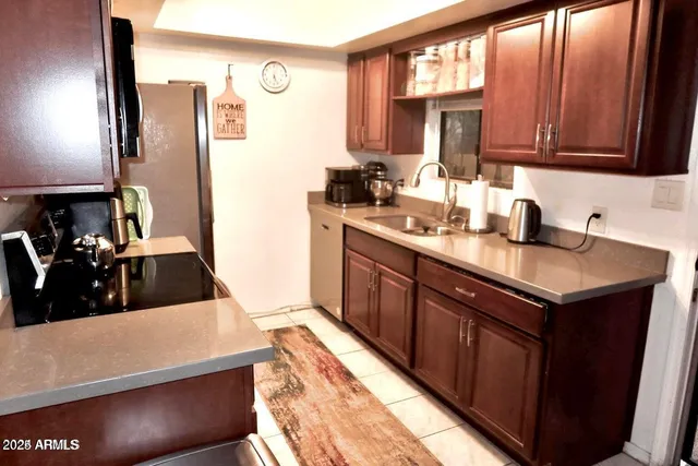 a kitchen with a sink a stove and cabinets