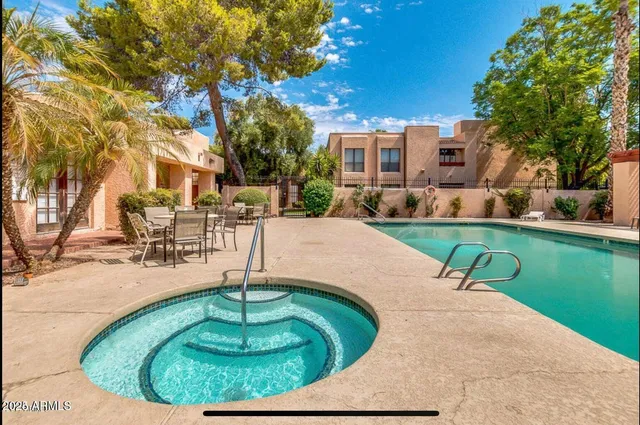 a swimming pool with outdoor seating and yard