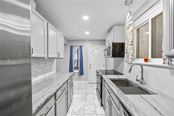 a kitchen with a sink stove and cabinets