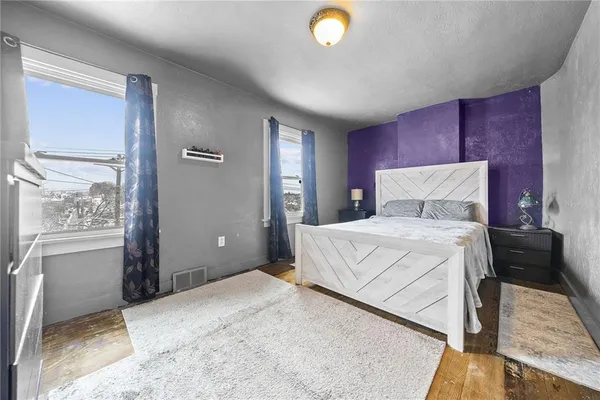 a bedroom with a large bed and a chandelier