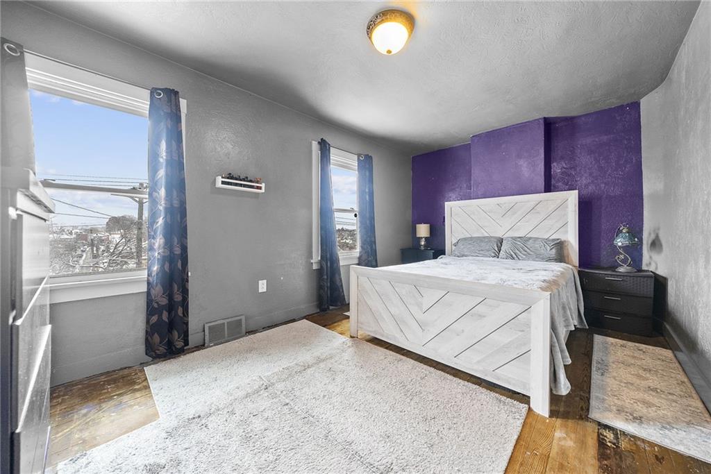 20 Haberman Avenue Pittsburgh, PA 15211 - Photo 14 of 22 a bedroom with a large bed and a chandelier