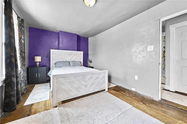 a bed room with a bed and a window