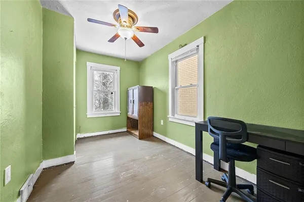 a view of a workspace with furniture and a window