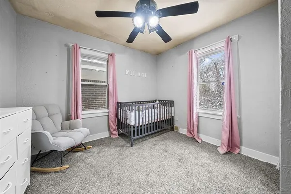 a spacious bedroom with a bed and a chandelier