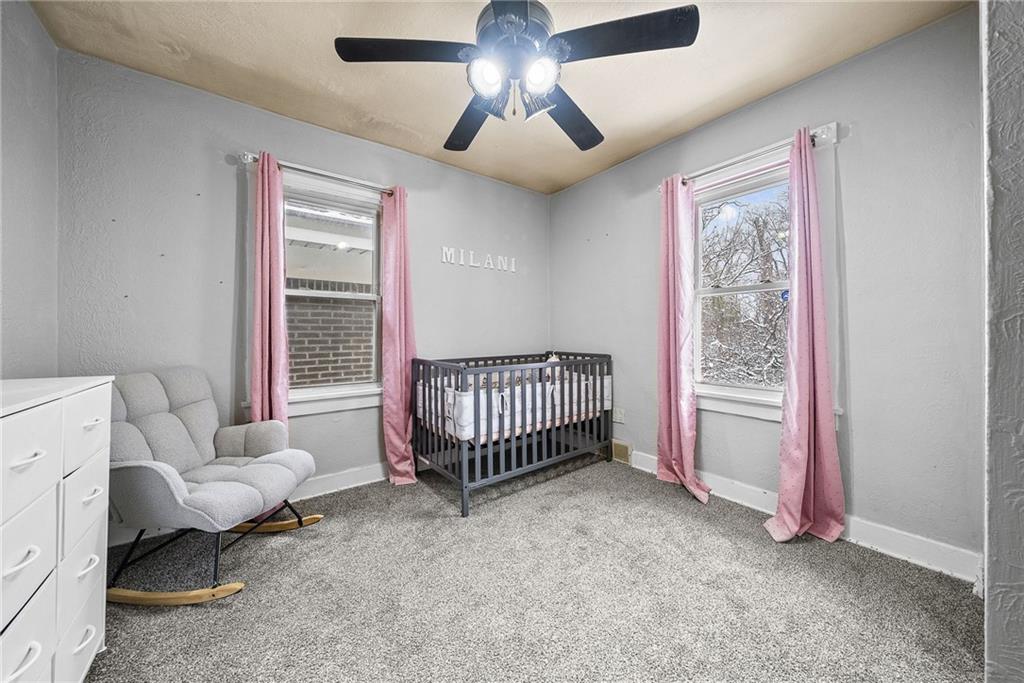 20 Haberman Avenue Pittsburgh, PA 15211 - Photo 18 of 22 a spacious bedroom with a bed and a chandelier