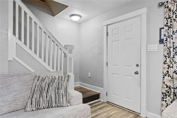 a view of entryway and hall with wooden floor