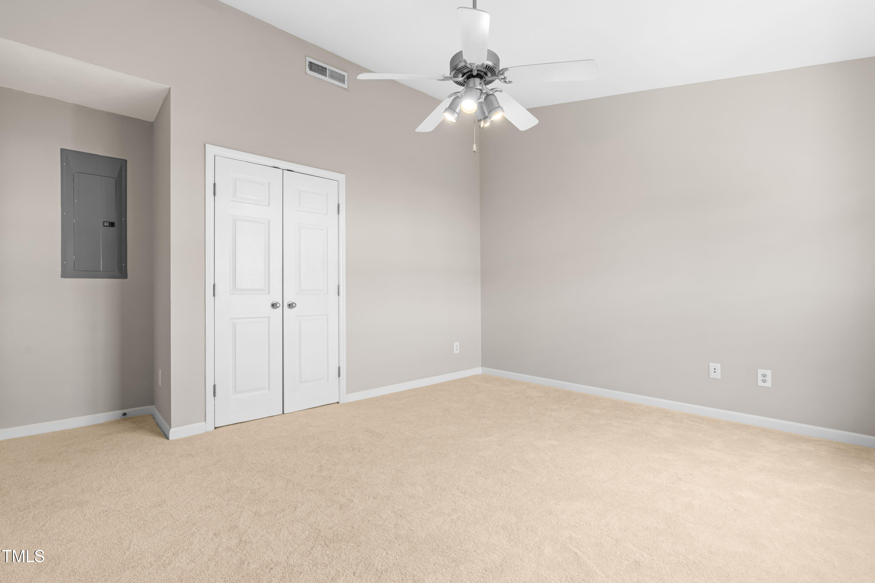 2101 Piney Brook Road, Unit 105 Raleigh, NC 27614 - Photo 12 of 24 a view of an empty room with a chandelier fan