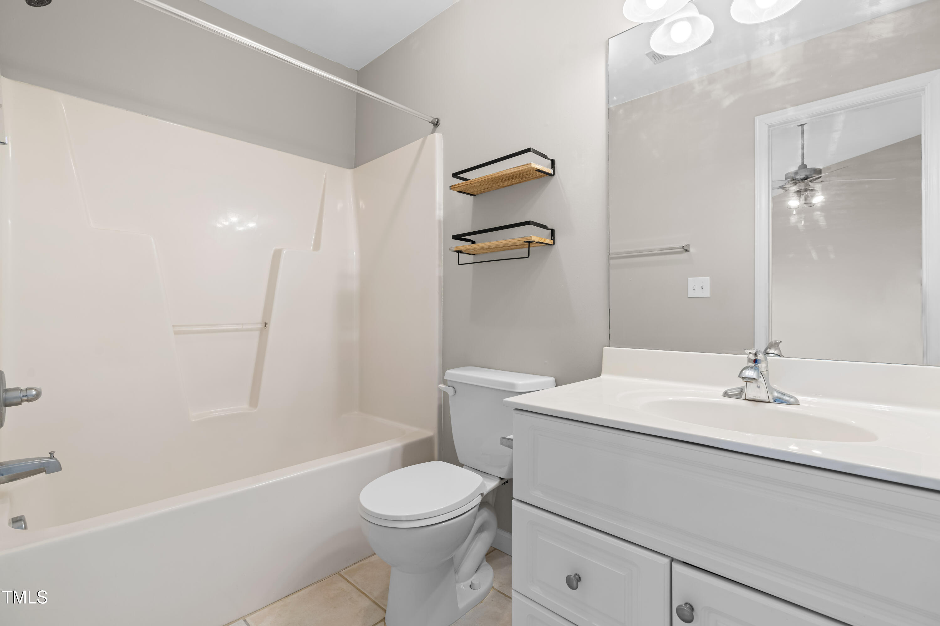 2101 Piney Brook Road, Unit 105 Raleigh, NC 27614 - Photo 13 of 24 a bathroom with a sink a toilet and shower