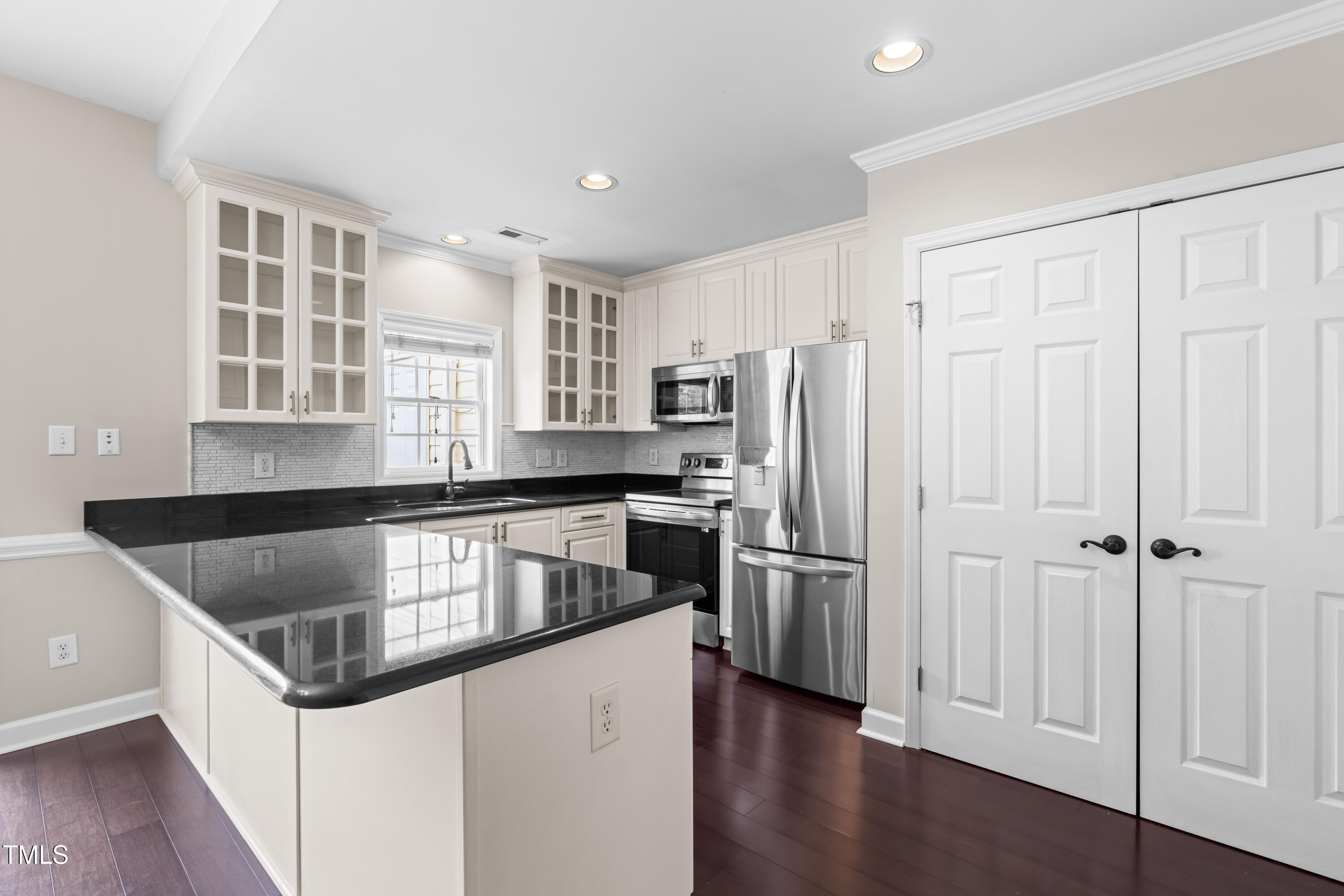 2101 Piney Brook Road, Unit 105 Raleigh, NC 27614 - Photo 8 of 24 a kitchen with stainless steel appliances granite countertop a refrigerator and a sink