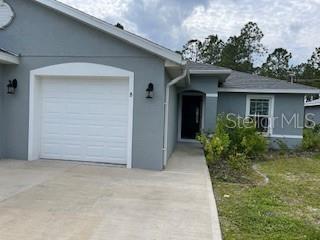 41 Freneau Lane, Unit B Palm Coast, FL 32137 - Photo 1 of 1 front view of house with potted plants