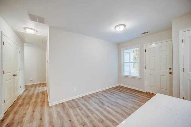 a view of a room with wooden floor and bathroom
