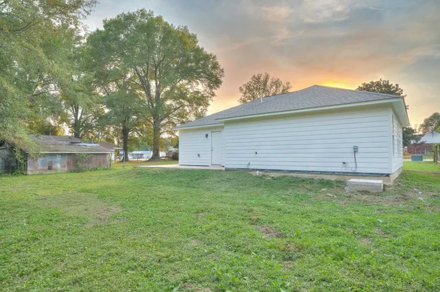 a view of a backyard with a large tree