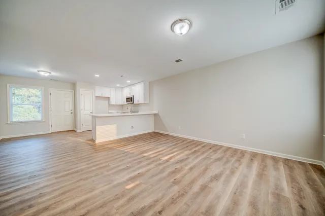a view of kitchen with wooden floor and windows