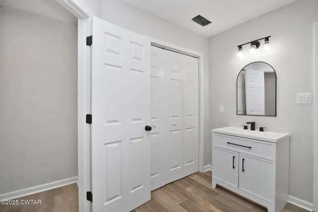 a room with two mirror and a sink