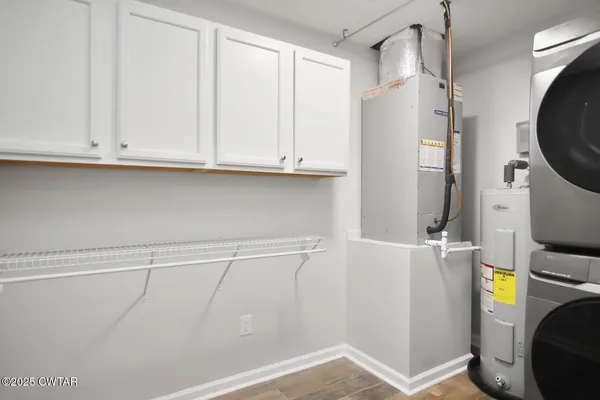 a view of cabinets and utility room with refrigerator