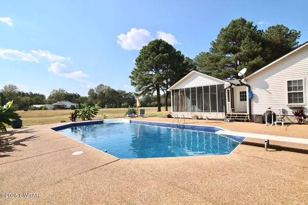 a view of a house with swimming pool and sitting area