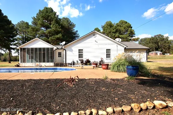 a view of a house with swimming pool and a yard
