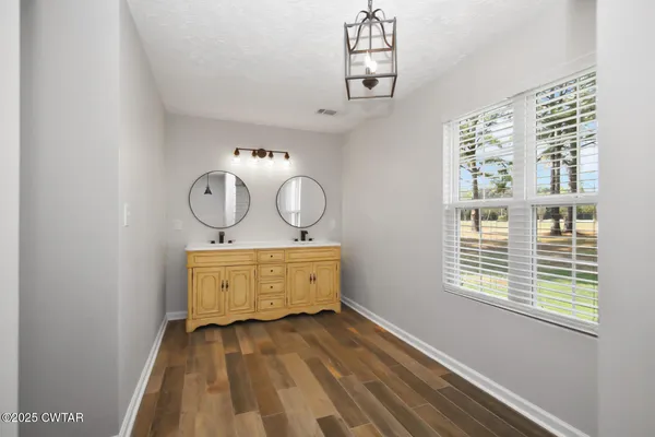 a view of a room with wooden floor