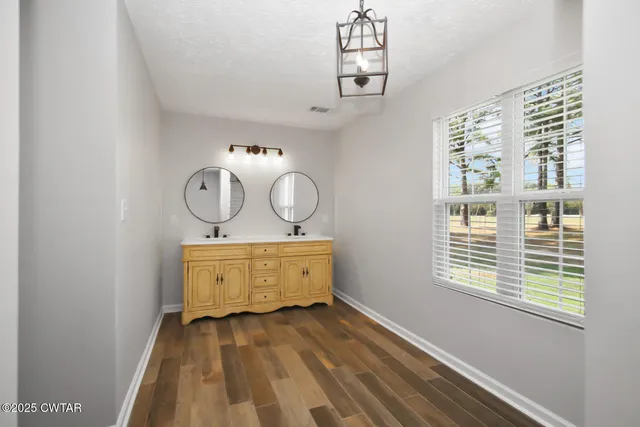 a view of a room with wooden floor