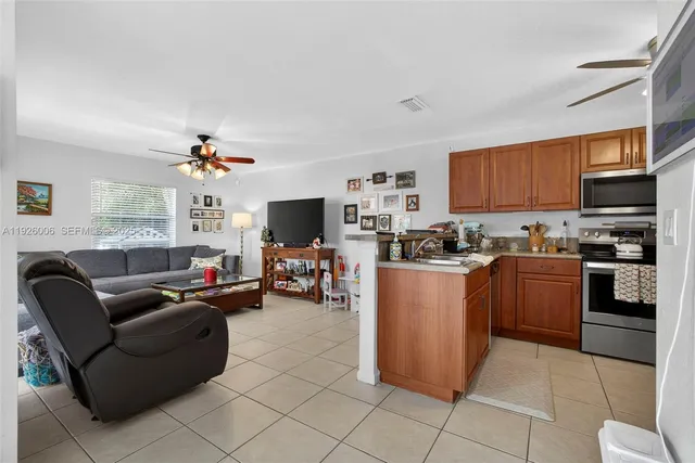 a kitchen with stainless steel appliances granite countertop a stove top oven a refrigerator a sink and dishwasher
