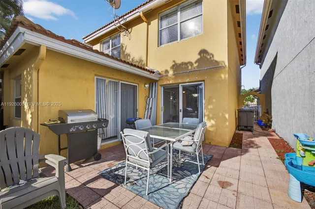 a view of a house with backyard porch and sitting area