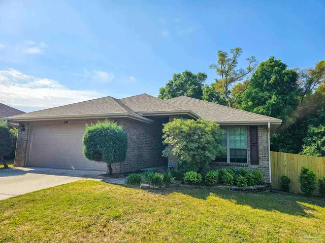 a view of a house with pool and garden