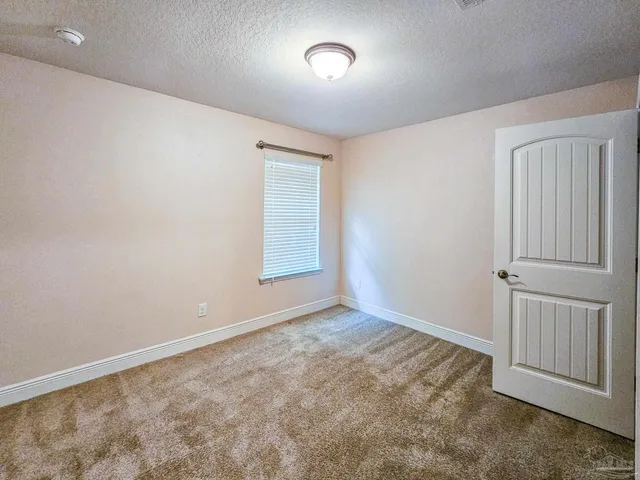 an empty room with closet area