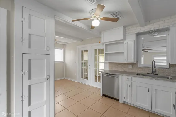 a view of room with a ceiling fan and window