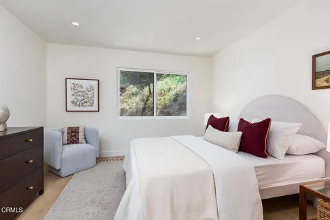 a bedroom with a bed and a couch