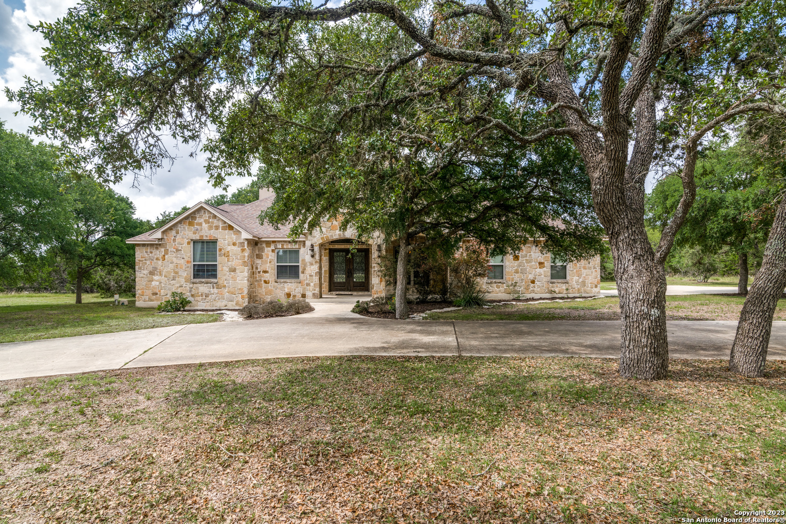 111 Lily Street Spring Branch, TX 78070 - Photo 1 of 1 a front view of a house with a yard and tree